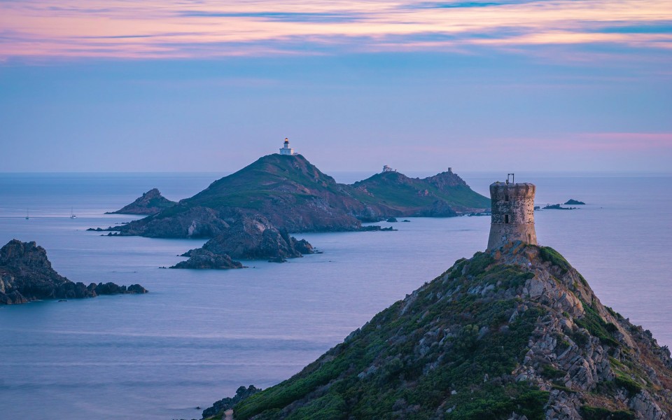 View of the Sanguinaires Islands off the coast of Ajaccio in Corsica, with the sun setting over the Mediterranean